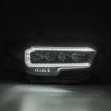 AlphaRex 16-20 Toyota Tacoma NOVA LED Projector Headlight Plank Style Alpha Black w/Activation Light - 880705