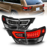 ANZO 11-13 Jeep Grand Cherokee LED Taillights w/ Lightbar Black Housing/Clear Lens 4pcs - 311439